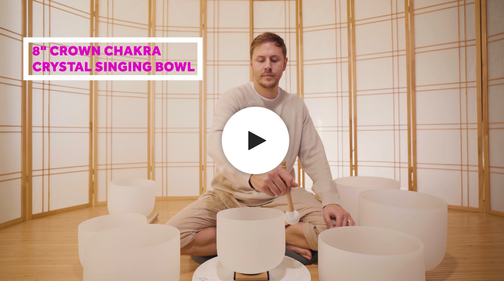 Man playing crown chakra crystal singing bowl