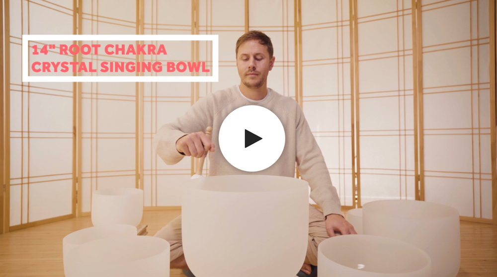 Man playing root chakra crystal singing bowl