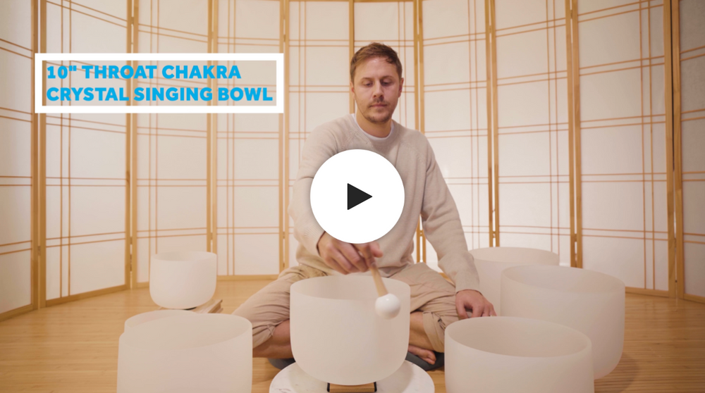 Man playing throat chakra crystal singing bowl