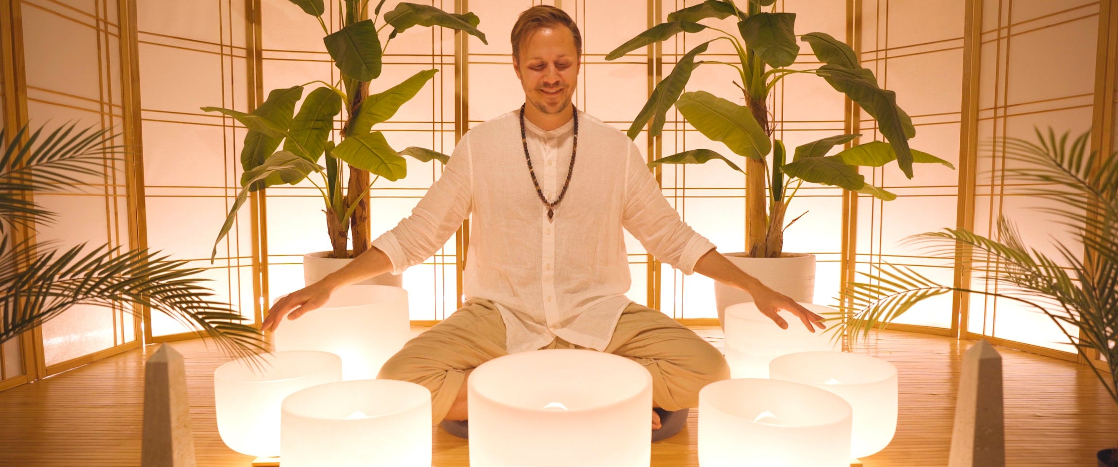 Travis Schumacher surrounded by crystal singing bowls