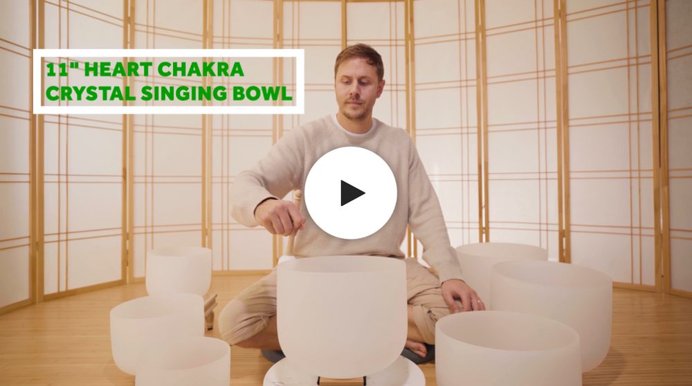 Man playing heart chakra crystal singing bowl