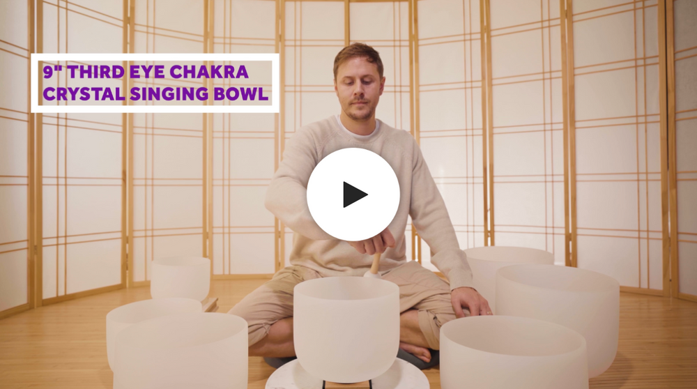 Man playing third eye crystal singing bowl