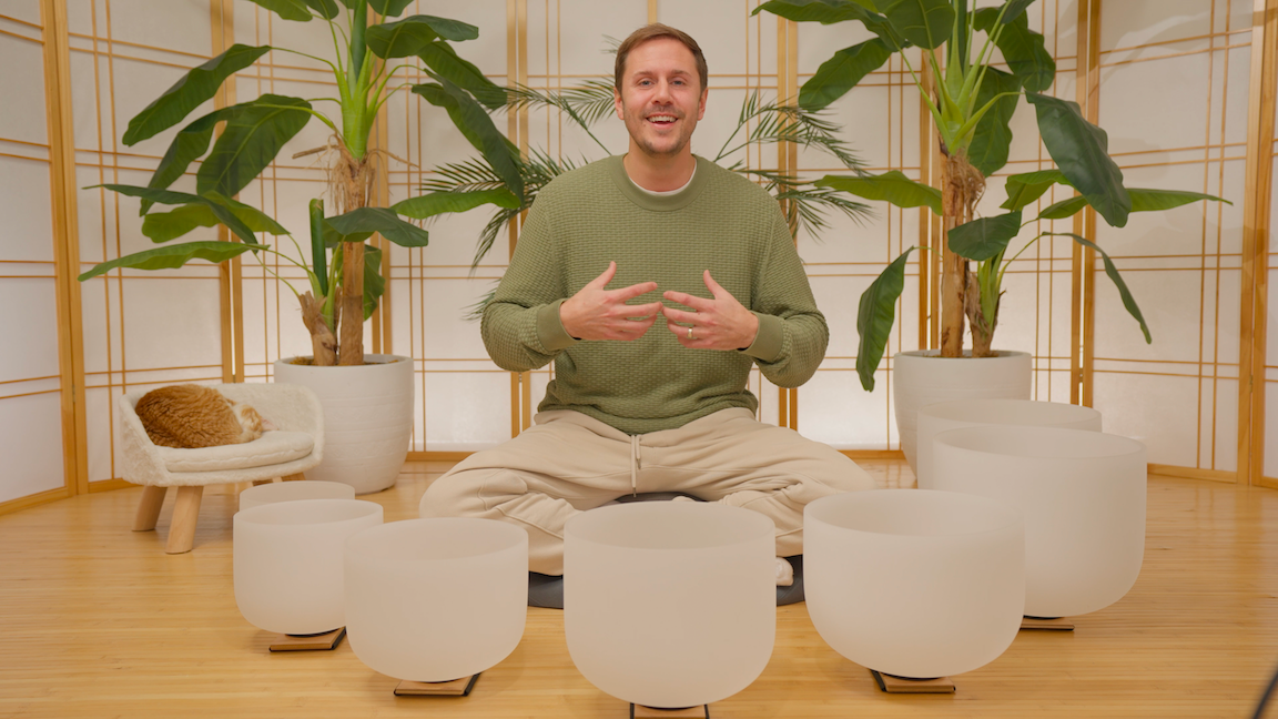 Travis teaching crystal singing bowls in his studio